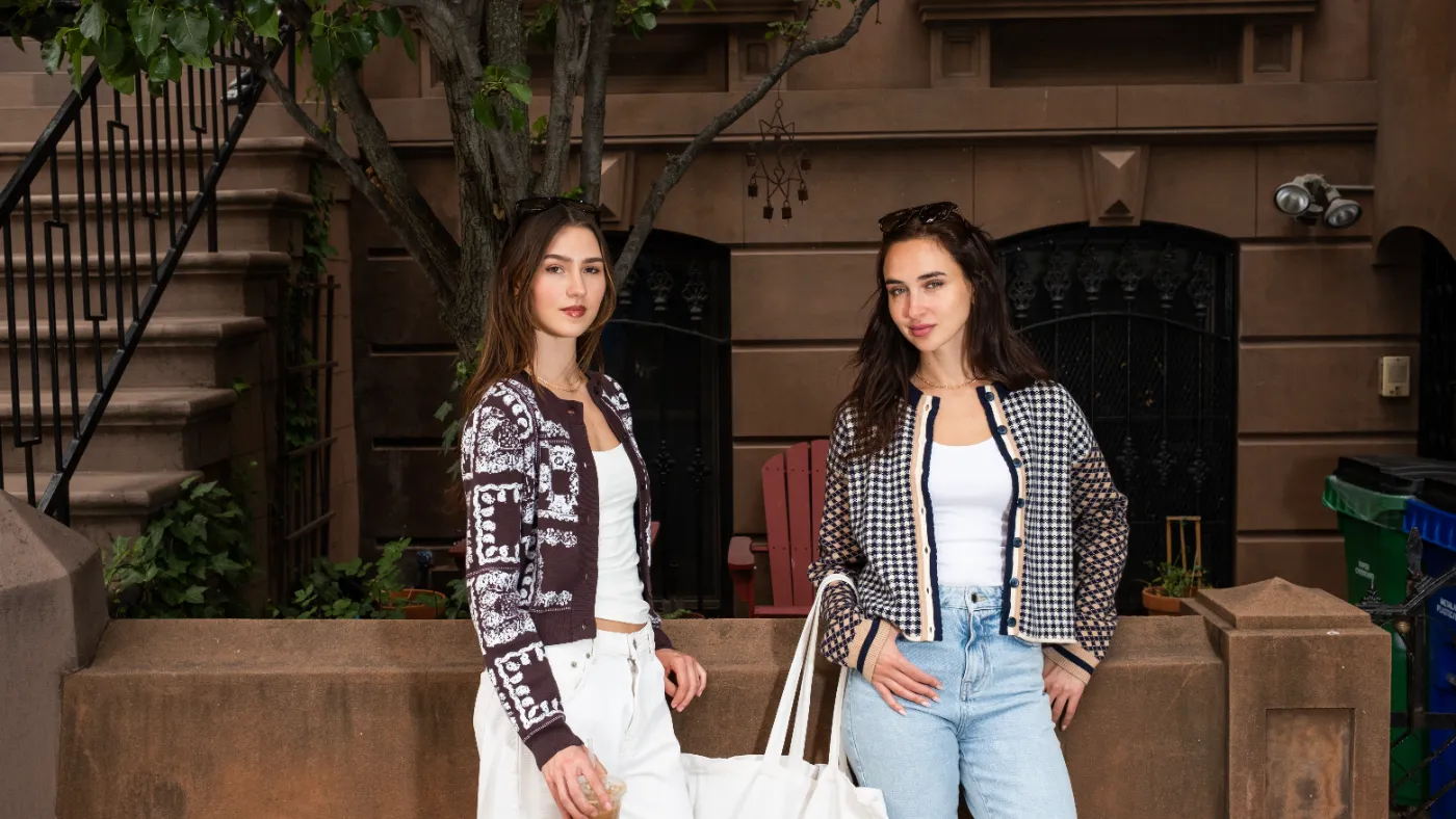 Two models in Central Park West sweaters standing on a New York stoop
