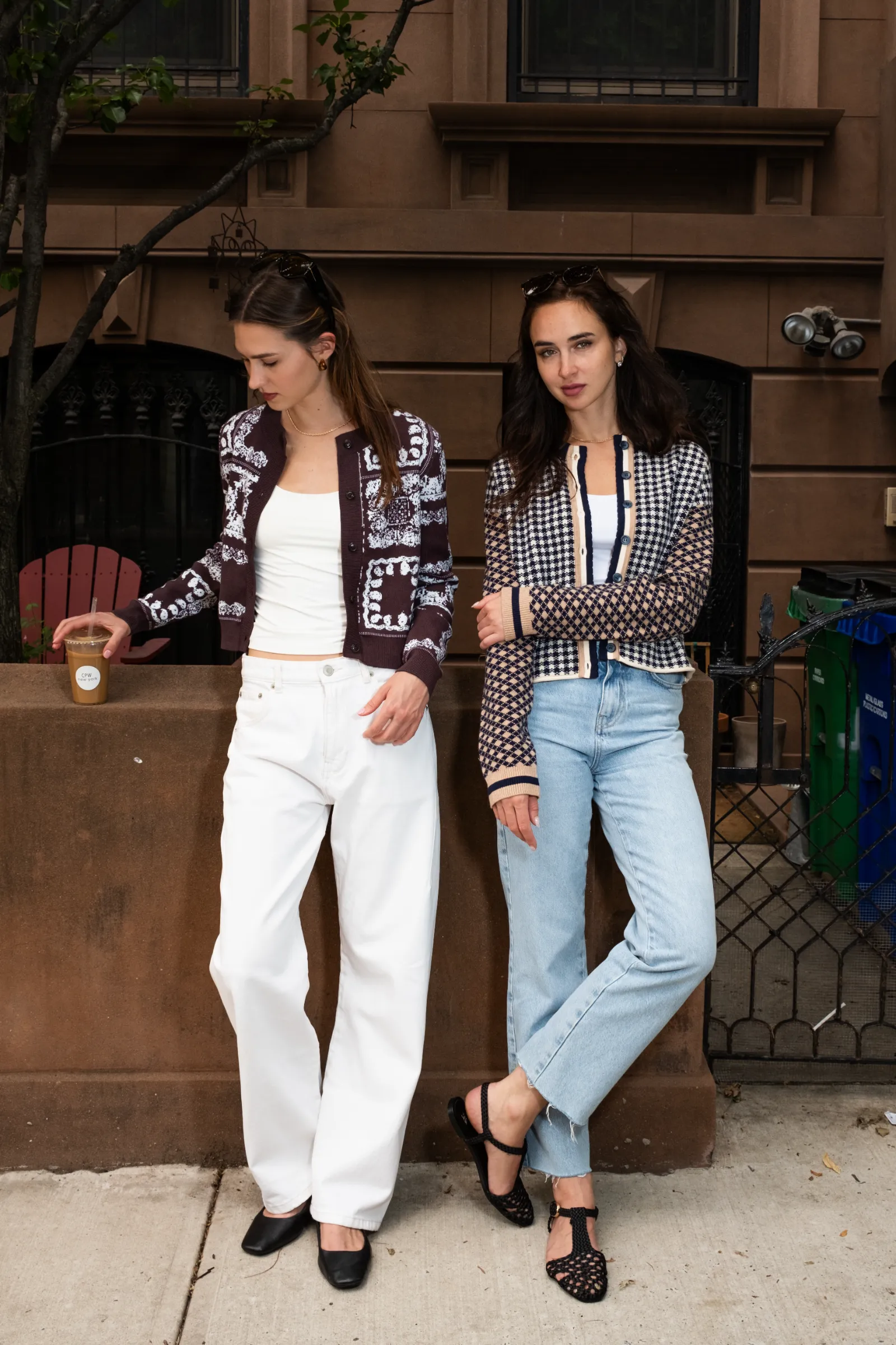 Two models in Central Park West knitwear and denim on a brownstone stoop in New York